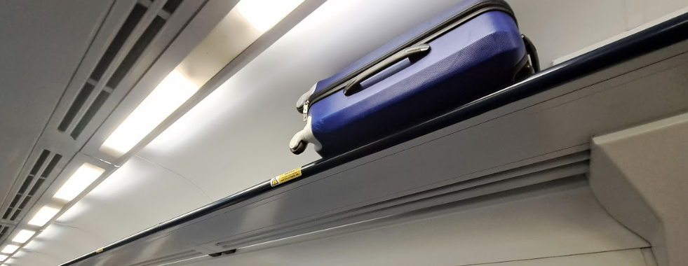 suitcase in overhead rack on northern train