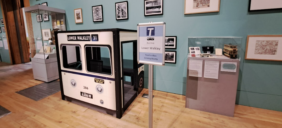 display in weston park museum, including a bus cab, bus stop and model of a tram