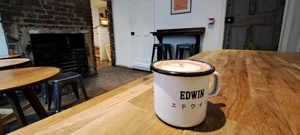 interior of the steam yard cafe, showing an empty room with a mug of chai on the table