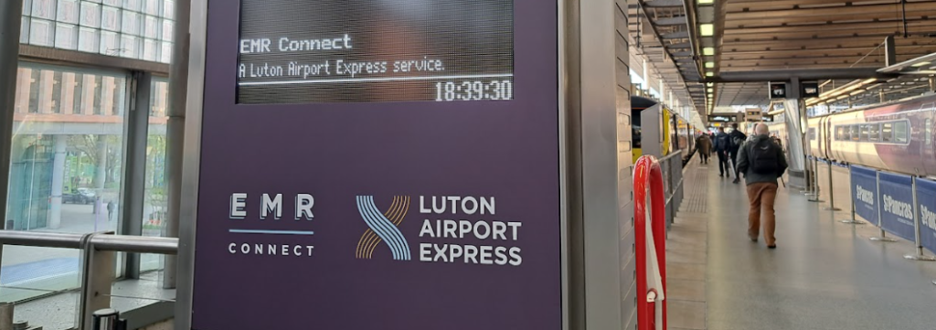 departure screen showing luton airport express branding at st pancras