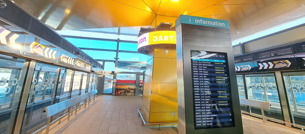 luton airport parkway dart station showing flight info boards